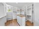 Large walk-in closet with custom shelving and wood floors at 2829 Theresa Eileen Way, Raleigh, NC 27603
