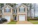 Charming two-story townhome featuring a stone accent, a one car garage and a well-maintained lawn at 2832 Egert Dr, Haw River, NC 27258