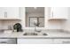 Close up of kitchen sink with granite countertops, white cabinets, and stainless steel faucet at 2832 Egert Dr, Haw River, NC 27258