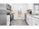 Bright kitchen with stainless steel appliances, white cabinets, granite countertops and access to backyard at 2832 Egert Dr, Haw River, NC 27258