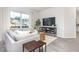 Inviting living room features a large window, neutral decor, wood floors and comfortable seating at 2832 Egert Dr, Haw River, NC 27258