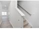 Bright entryway featuring carpeted stairs, wood-look flooring, and white walls at 2834 Egert Dr, Haw River, NC 27258