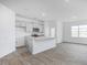 Open-concept kitchen with gray cabinets, granite countertops, and stainless steel appliances at 2834 Egert Dr, Haw River, NC 27258