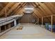 Unfinished attic space with wooden beams and a partially carpeted floor, offering potential for storage or conversion at 3001 Hunters Bluff Dr, Raleigh, NC 27606