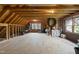 Unfinished attic space with exposed wooden beams and a window at 3001 Hunters Bluff Dr, Raleigh, NC 27606