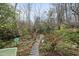 A backyard walkway meanders through lush gardens and native plantings at 3001 Hunters Bluff Dr, Raleigh, NC 27606