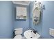 Bathroom featuring blue walls, pedestal sink, and decorative mirror at 3001 Hunters Bluff Dr, Raleigh, NC 27606