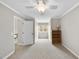 Neutral bedroom with a ceiling fan, window, an open door, and a bookcase at 3001 Hunters Bluff Dr, Raleigh, NC 27606