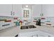 Kitchen featuring white cabinets, subway tile backsplash, and stainless steel sink at 3001 Hunters Bluff Dr, Raleigh, NC 27606