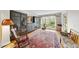 Bright living room with hardwood floors, large windows, and cozy rocking chair at 3001 Hunters Bluff Dr, Raleigh, NC 27606