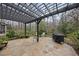 Stone patio features a pergola, grill, and a lush landscaped background at 3001 Hunters Bluff Dr, Raleigh, NC 27606