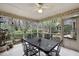 Screened porch with tile floor, string lights, a table, and views of the backyard at 3001 Hunters Bluff Dr, Raleigh, NC 27606