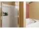 Bathroom features a tub and shower, with toiletries, white tile, glass door and traditional trim at 3007 Cardinal Lake Dr, Durham, NC 27704