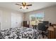 Bright bedroom with ceiling fan, large window, dresser, and desk setup; perfect for work or study at 3007 Cardinal Lake Dr, Durham, NC 27704