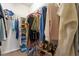 Organized walk-in closet with clothing racks, shelves, and space for shoes and folded items at 3007 Cardinal Lake Dr, Durham, NC 27704