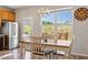 Dining area adjacent to the kitchen featuring natural light and hardwood floors at 3007 Cardinal Lake Dr, Durham, NC 27704