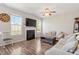 Living room featuring a fireplace, large windows, and hardwood floors at 3007 Cardinal Lake Dr, Durham, NC 27704
