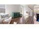 Open-concept living room featuring hardwood floors, comfortable seating, and a bright window at 3007 Cardinal Lake Dr, Durham, NC 27704