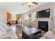 Open-concept living room featuring a fireplace, hardwood floors, and kitchen access at 3007 Cardinal Lake Dr, Durham, NC 27704