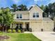 Charming two-story home with a well-manicured lawn and inviting front porch at 303 Fortress Dr, Morrisville, NC 27560