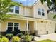 Two-story home with inviting front porch, well-manicured lawn, and a two car garage at 303 Fortress Dr, Morrisville, NC 27560