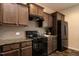 Well-equipped kitchen features stainless steel appliances and stylish brown cabinets at 303 Fortress Dr, Morrisville, NC 27560