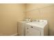 Functional laundry room with modern appliances and a storage shelf at 303 Fortress Dr, Morrisville, NC 27560
