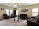 Bright living room featuring neutral tones, large windows, and ample seating at 303 Fortress Dr, Morrisville, NC 27560