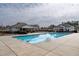 Community pool with pristine water, surrounded by lounge chairs, and well-maintained landscaping at 303 Fortress Dr, Morrisville, NC 27560