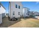 Image displays the backyard with a lawn, utility infrastructure, and the rear view of the home with its patio and entrance at 305 Wash Hollow Dr, Wendell, NC 27591