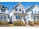 Charming home featuring a welcoming front porch and beautiful landscaping at 305 Wash Hollow Dr, Wendell, NC 27591