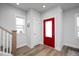 Bright foyer featuring beautiful hardwood floors and a vibrant red front door at 305 Wash Hollow Dr, Wendell, NC 27591