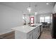 Modern open kitchen with stainless steel appliances, quartz countertops and breakfast bar at 305 Wash Hollow Dr, Wendell, NC 27591