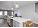 Bright open kitchen featuring a large island with seating and modern pendant lighting at 305 Wash Hollow Dr, Wendell, NC 27591