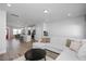 Open-concept living room with a comfortable sectional sofa and kitchen access at 305 Wash Hollow Dr, Wendell, NC 27591
