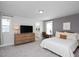 Spacious main bedroom with a dresser, desk, ensuite bathroom, and ample natural light at 305 Wash Hollow Dr, Wendell, NC 27591