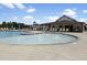 Community pool featuring lounge chairs, shaded areas, and a shallow wading area with fountains at 305 Wash Hollow Dr, Wendell, NC 27591
