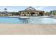 Community pool area featuring ample seating, a covered lounge area, and a clear blue pool at 305 Wash Hollow Dr, Wendell, NC 27591