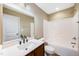 Modern bathroom featuring a stylish vanity, large mirror, and a shower-tub combination at 317 Michigan Ave, Cary, NC 27519