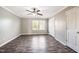 A bright bedroom featuring a ceiling fan and window with grey walls and modern vinyl flooring at 317 Michigan Ave, Cary, NC 27519