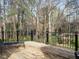 Wood back deck featuring a decorative railing and a bench overlooking the wooded backyard at 3321 Marblehead Ln, Raleigh, NC 27612