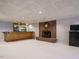 Finished basement featuring a brick fireplace and a wet bar, perfect for entertaining at 3321 Marblehead Ln, Raleigh, NC 27612
