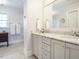 Well-lit bathroom with a double vanity, marble countertop, and modern fixtures at 3321 Marblehead Ln, Raleigh, NC 27612