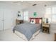 Neutral bedroom with white walls, a checkered bedspread, and natural light streaming in through plantation shutters at 3321 Marblehead Ln, Raleigh, NC 27612