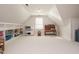 Large bonus room with built-in shelves and ample natural light, ideal for a playroom or entertainment area at 3321 Marblehead Ln, Raleigh, NC 27612
