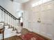 Inviting foyer with hardwood floors, staircase, and natural light, showcasing the home's elegant entrance at 3321 Marblehead Ln, Raleigh, NC 27612