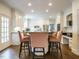 Eat-in kitchen with white cabinets, a center island, and stainless steel appliances, perfect for everyday meals at 3321 Marblehead Ln, Raleigh, NC 27612