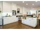 Open-concept kitchen features white cabinets, a center island, and modern appliances at 3321 Marblehead Ln, Raleigh, NC 27612