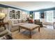Bright living room with custom bookshelves, ample seating, and natural light, ideal for Gathering gatherings at 3321 Marblehead Ln, Raleigh, NC 27612