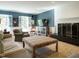 Comfortable living room with blue accent walls, fireplace, and large windows, creating a welcoming atmosphere at 3321 Marblehead Ln, Raleigh, NC 27612